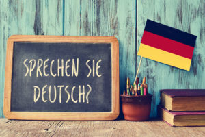 a chalkboard with the question sprechen sie deutsch? do you speak German with German flag